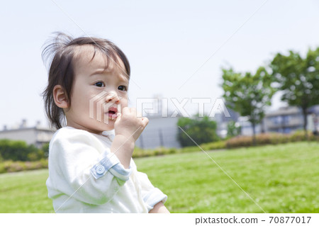 A boy playing in a park 70877017