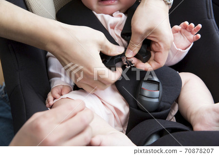 Baby sitting on the baby seat 70878207