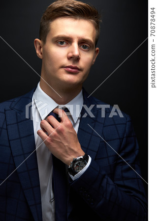 confident business man in formal tux or suit expresses his greatness and influence through his eyes 70878494