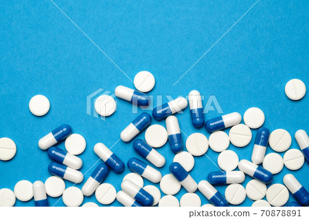 group of pills or capsules on blue background group of pills or capsules on blue background 70878891