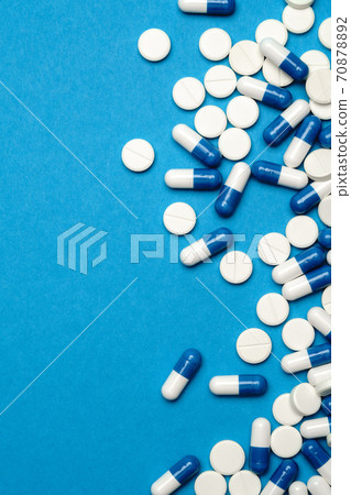 group of pills or capsules on blue background group of pills or capsules on blue background 70878892
