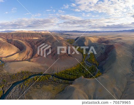 Red Hills of Clay, Mountains, Larches and River in Autumn. Aerial View. Kokorya. The Altai Mountains Red Hills of Clay, Mountains, Larches and River in Autumn. Aerial View. Kokorya. The Altai Mountains 70879965