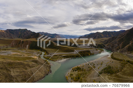 The confluence of Chuya and Katun rivers in Autumn. Green Hills and Mountains. Aerial View. The The confluence of Chuya and Katun rivers in Autumn. Green Hills and Mountains. Aerial View. The 70879966