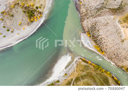 The confluence of Chuya and Katun rivers in Autumn. Aerial Top-Down View. The Altai Mountains The confluence of Chuya and Katun rivers in Autumn. Aerial Top-Down View. The Altai Mountains 70880047