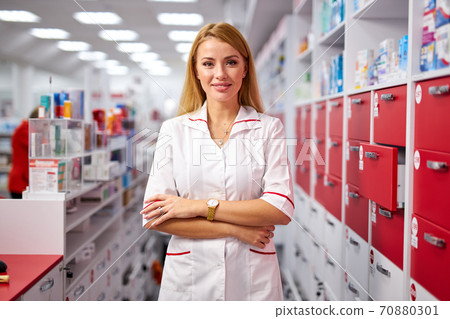 portrait of beautiful young woman pharmacist at modern drugstore portrait of beautiful young woman pharmacist at modern drugstore 70880301