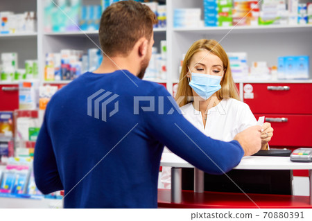 young professional druggist give medications to customer in modern drugstore 70880391