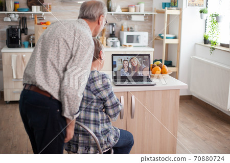 Senior couple talking with niece Senior couple talking with niece 70880724