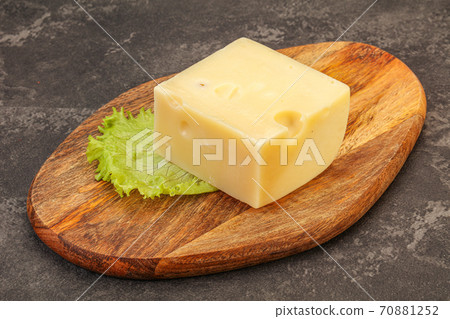 Emmental cheese over wooden board Emmental cheese over wooden board 70881252