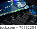 Stock market chart screen on keyboard computer and eyeglasses, online investment concept 70882254