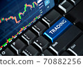 Stock market chart screen on keyboard computer and blue trading button, online investment concept 70882256
