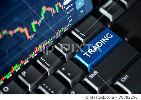 Stock market chart screen on keyboard computer and blue trading button, online investment concept 70882256