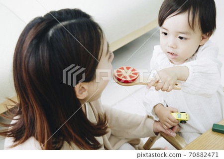 Parent and child playing with toys Parent and child playing with toys 70882471