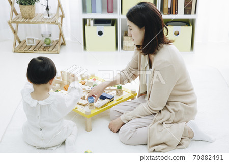 Parent and child playing with toys Parent and child playing with toys 70882491