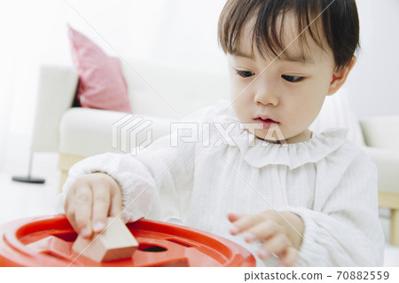Infants playing with toys 70882559