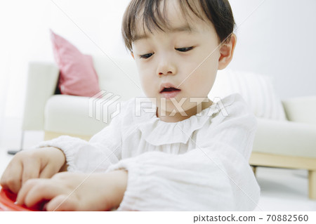 Infants playing with toys Infants playing with toys 70882560
