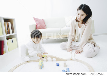 Parent and child playing with toys 70882566