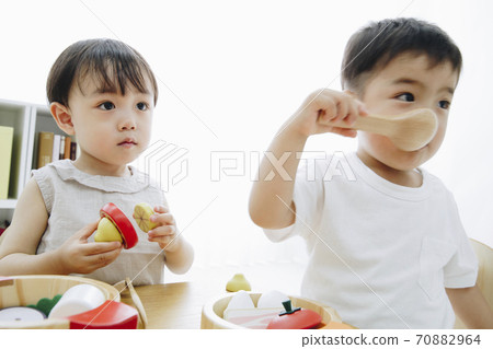 A boy playing with a toy A boy playing with a toy 70882964