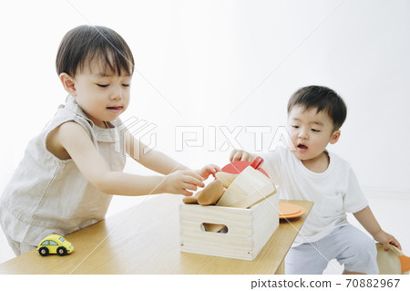 A boy playing with a toy A boy playing with a toy 70882967