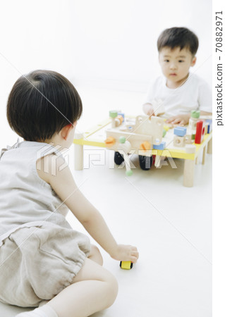 A boy playing with a toy A boy playing with a toy 70882971