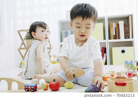 Infants playing with toys Infants playing with toys 70883213