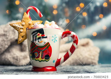 Warm marshmallow dessert beverage on Christmas decorated table 70883423