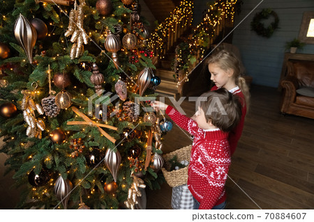 Little kids have fun decorating Christmas tree at home 70884607