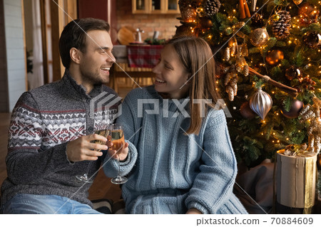 Happy couple celebrate New Year near Christmas tree 70884609