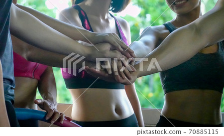 Unrecognizable woman clasps hands, Friends Expressing Togetherness And Clasping Hands Together 70885115