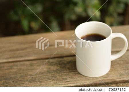Coffee placed on an outdoor table 70887152