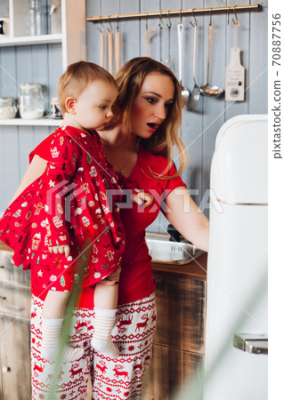 Mom holding by hand little daughter , showing and Mom holding by hand little daughter , showing and 70887756