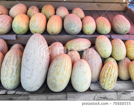 Group of ripe and fresh melon at farmers market. Food shop with vegetables. Mobile photo 70888555
