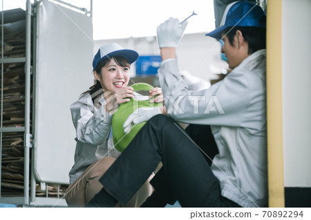 A young woman handing a handmade lunch at work 70892294