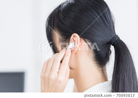Woman wearing wireless earphones 70893813