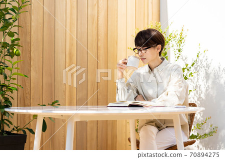 Women's terrace reading, relaxing lifestyle Women's terrace reading, relaxing lifestyle 70894275