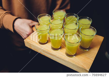 Various alcoholic shots in shot glasses in a serving tray often used for offers in the drinks industry. Various alcoholic shots in shot glasses in a serving tray often used for offers in the drinks industry. 70894627