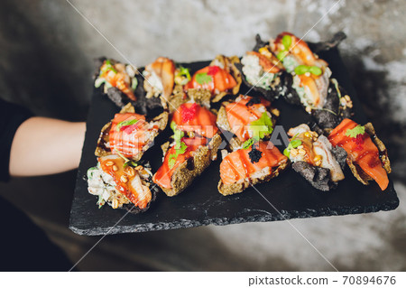 Canape, appetizers, on the table, buffet menu, European cuisine, shrimp, mini burger on a wooden background. Canape, appetizers, on the table, buffet menu, European cuisine, shrimp, mini burger on a wooden background. 70894676