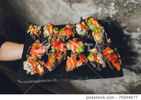 Canape, appetizers, on the table, buffet menu, European cuisine, shrimp, mini burger on a wooden background. Canape, appetizers, on the table, buffet menu, European cuisine, shrimp, mini burger on a wooden background. 70894677