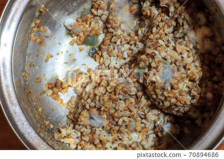 Fluffy fungi spores mold growing on buckwheat 70894686