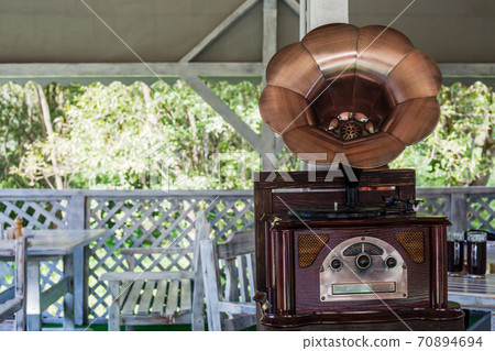 Phonograph with brass horn speaker on wood table 70894694