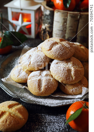 Winter festive baking. Homemade tangerine cookies, powdered sugar dressing. Winter festive baking. Homemade tangerine cookies, powdered sugar dressing. 70894741