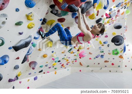 Woman bouldering 70895021
