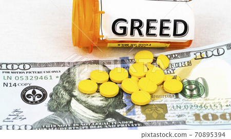 Greed written on pill bottle with money and yellow pills Greed written on pill bottle with money and yellow pills 70895394
