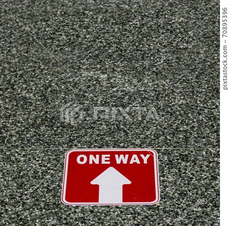 One way arrow on a floor af a high school for social distancing One way arrow on a floor af a high school for social distancing 70895396