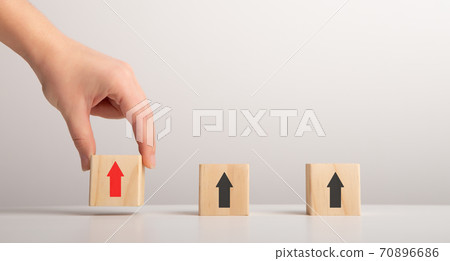 Female Hand Putting Wooden Blocks With Arrows Up, Gray Background 70896686