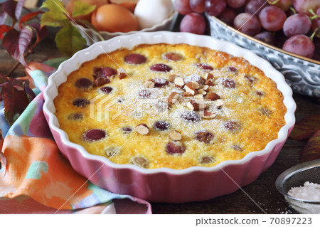 Red grape clafoutis, almonds dressing, french cuisine Red grape clafoutis, almonds dressing, french cuisine 70897223