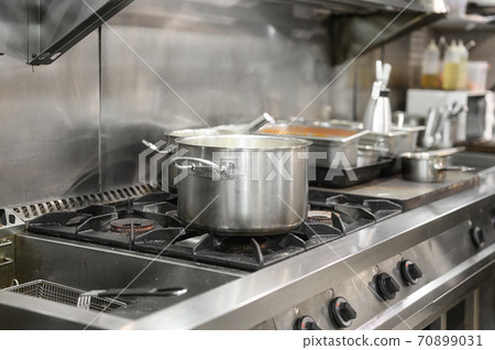 Stainless steel restaurant professional kitchen equipment and work surface.  70899031