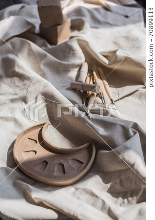 Table with materials and tools for pottery making craftsperson workspace no people creative studio top view 70899113