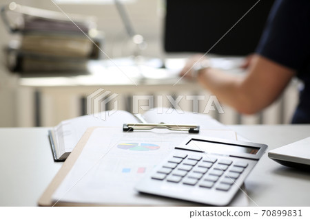 Black calculator and financial statistics on clipboard pad Black calculator and financial statistics on clipboard pad 70899831