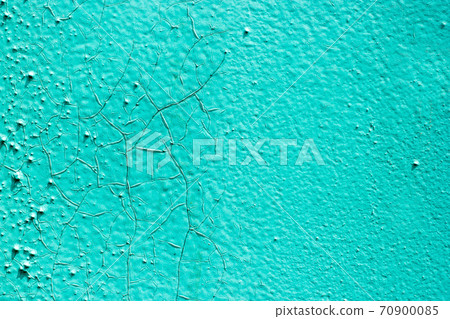 Surface of the old metal wall is covered with a lot of cracks, in which a rusty metal base is visible. Destruction of the old blue cracked paint. Grunge background texture. Surface of the old metal wall is covered with a lot of cracks, in which a rusty metal base is visible. Destruction of the old blue cracked paint. Grunge background texture. 70900085