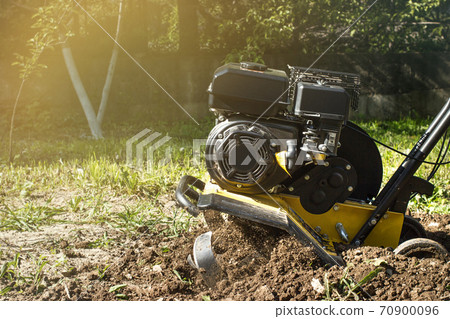 Spring garden outdoor works motor cultivator in process Spring garden outdoor works motor cultivator in process 70900096